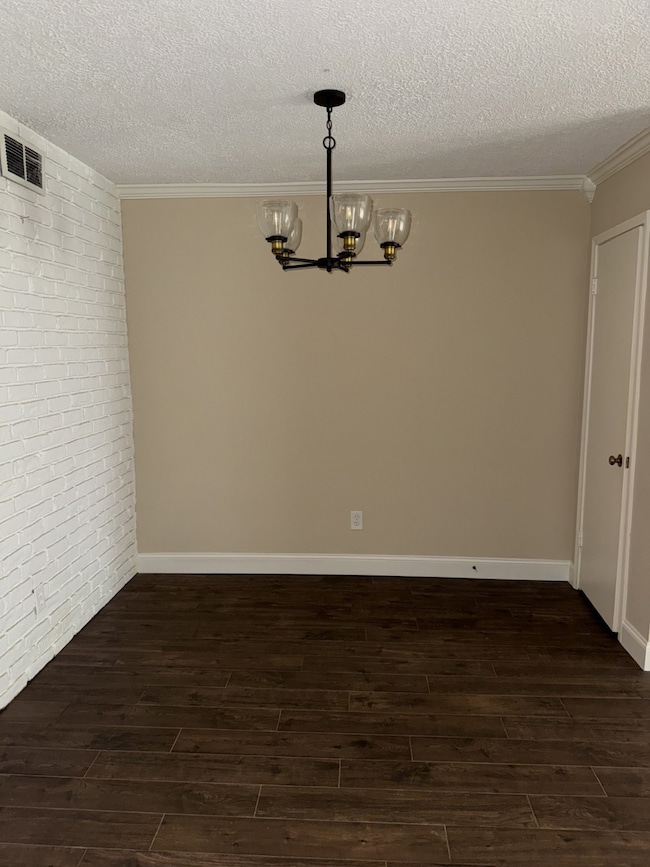 Cozy dining area has brick accent wall and extra closet
