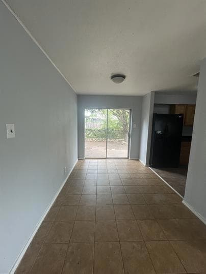 Unfurnished living room with baseboards and dark 