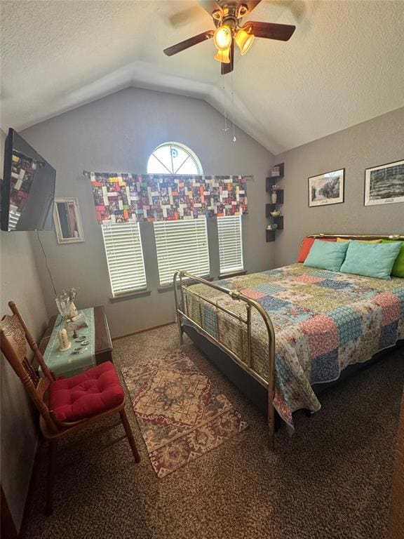 Bedroom featuring lofted ceiling, carpet flooring, a textured ceiling, and a ceiling fan