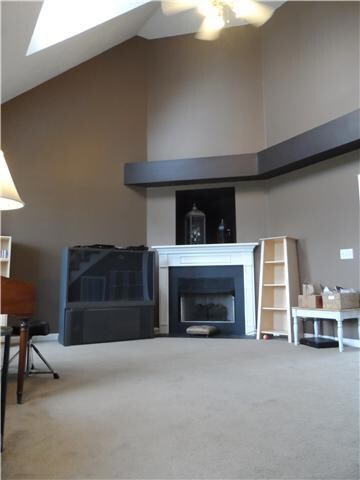 Bright, large living room right off entry with vaulted ceilings. New carpet and paint throughout the house. 