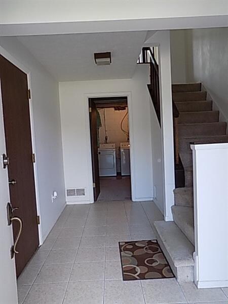 Spacious 13x9 Foyer leads into the laundry/storage