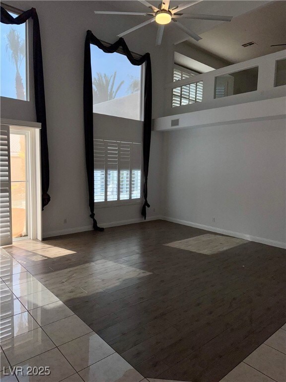Spare room featuring ceiling fan, a towering ceili