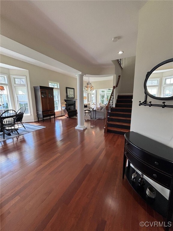 Living room featuring ornate columns, an inviting