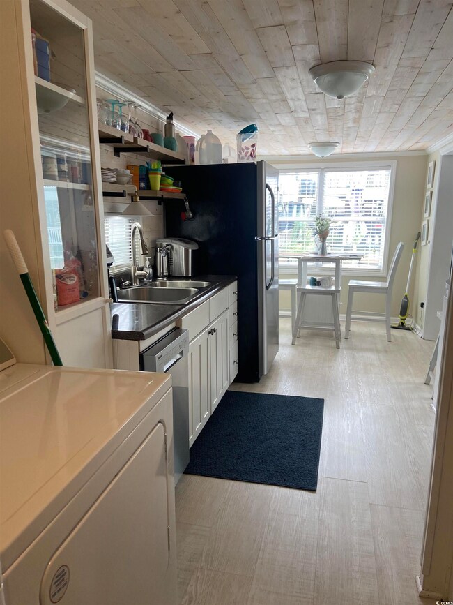 Kitchen featuring sink, washer / clothes dryer, di