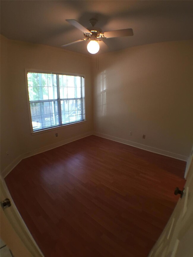 Spare room featuring baseboards, wood finished fl