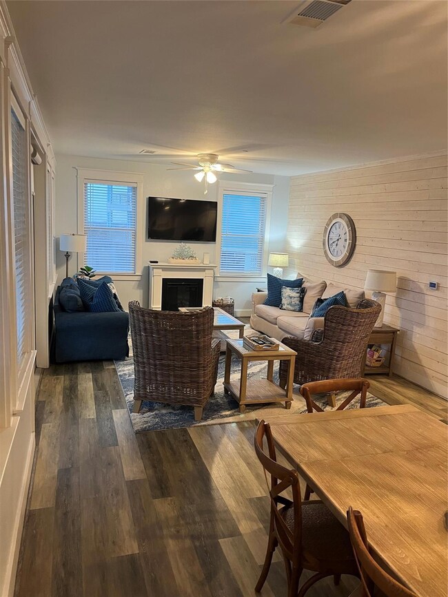 Living room featuring wooden walls, dark wood-type