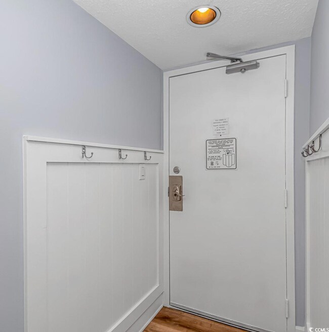 Entryway featuring a textured ceiling and wood finished floors