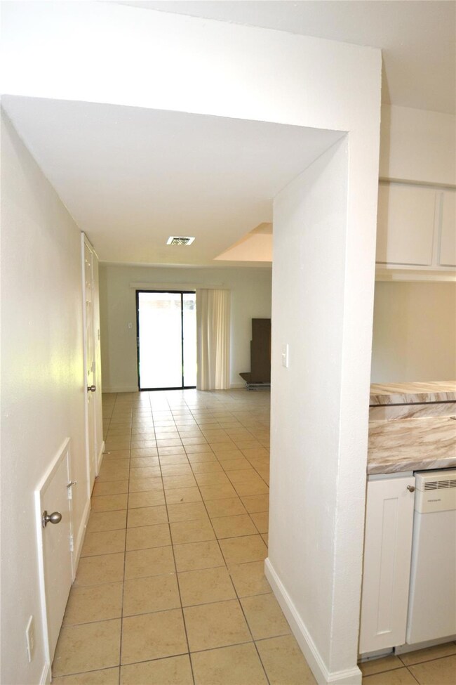 Corridor featuring light tile patterned floors