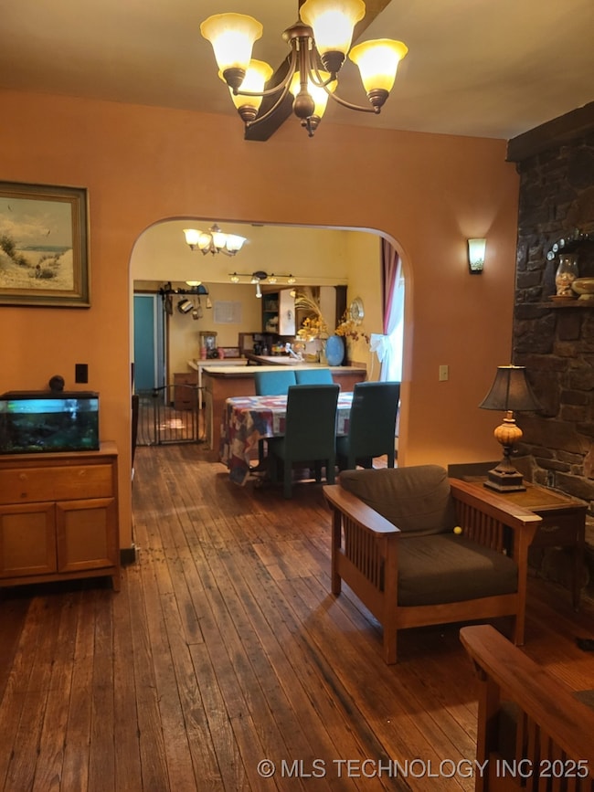 Arched doorway from den into the dining provides a