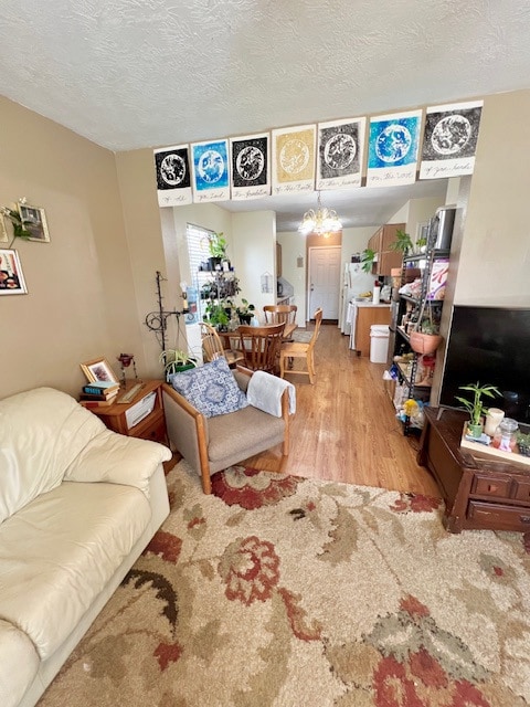 Living room with a textured ceiling, an inviting c
