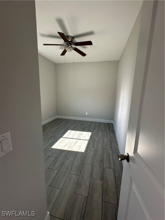 Empty room with hardwood / wood-style flooring and