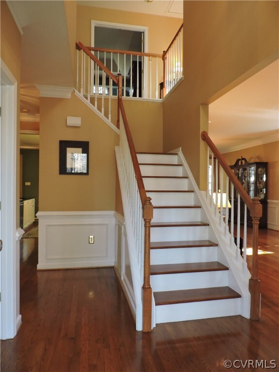 2-Story Foyer has beautiful wood staircase.