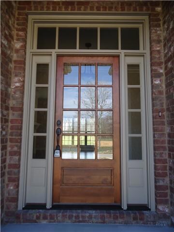 The entrance to this home is stunning with the transom door and side panels.