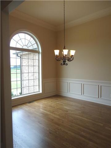 The formal dining room is also off the foyer.  With wainscotting, crown molding and a beautiful window, your guests will love to come for dinner!