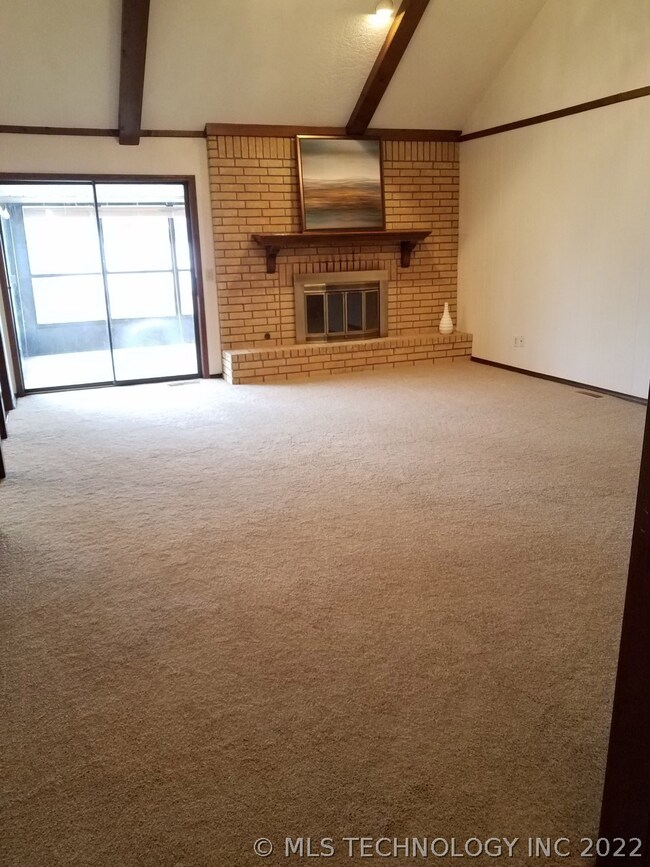 New carpet thru-out.  Beamed living with FP.  Glass doors lead to sun room.