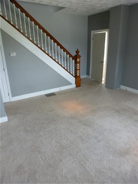 Living Room with orig staircase and newel post
