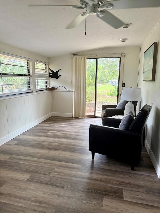 Living room with sliding doors that lead to private patio overlooking conservation