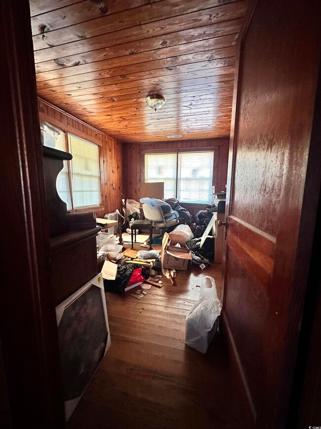 Misc room featuring wood walls, wood ceiling, and 