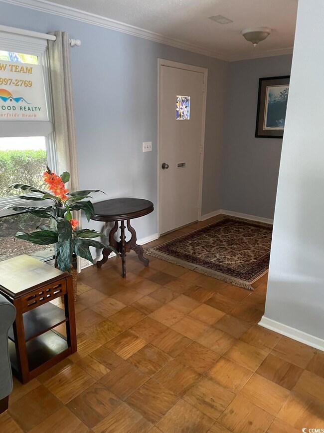 Foyer featuring baseboards and crown molding