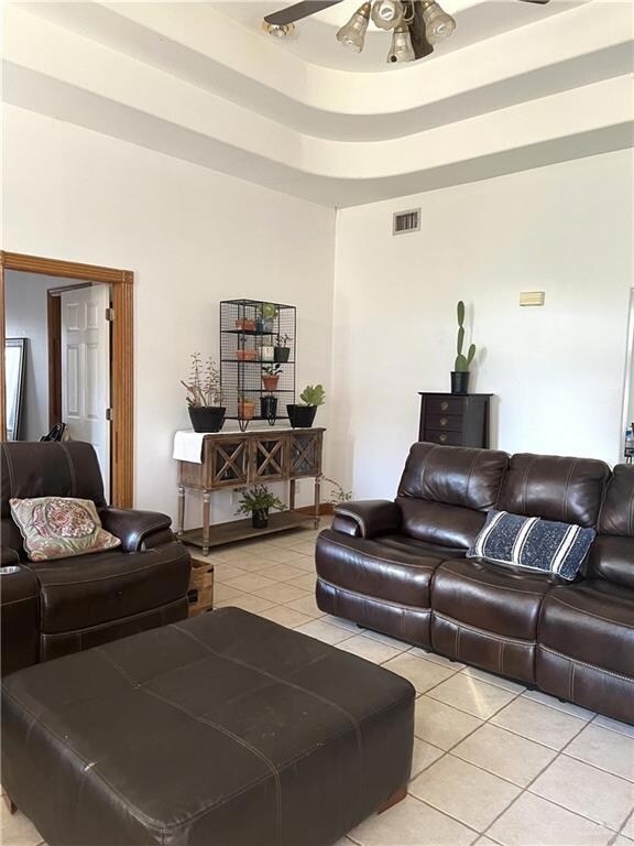Tiled living room featuring ceiling fan