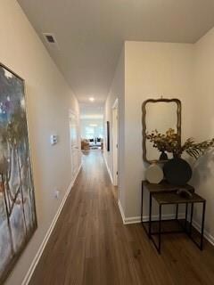 Corridor with wood finished floors and baseboards