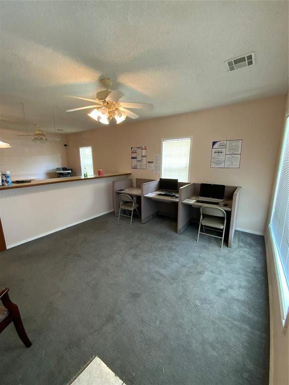 Unfurnished office with ceiling fan, dark colored 