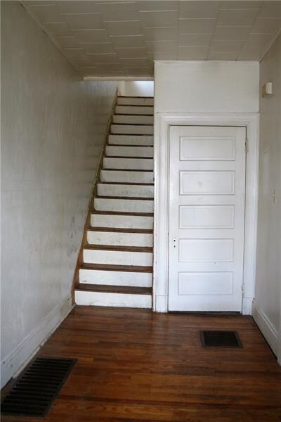 Entryway looking toward staircase and coat closet