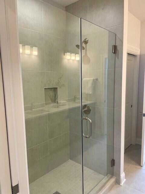 Tiled shower w/ frameless door