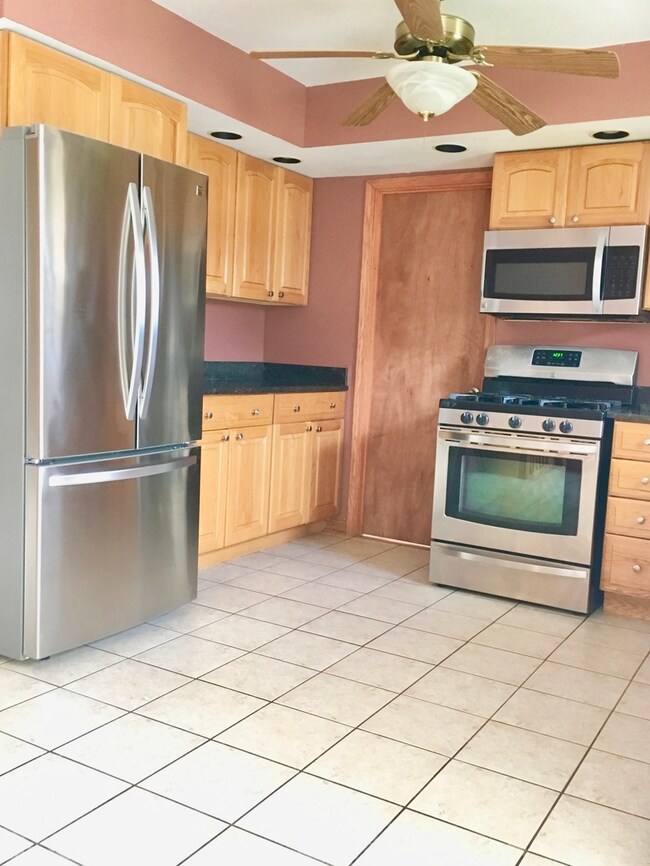 Other view of kitchen showcasing newer stainless s