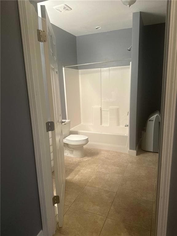Full bathroom featuring toilet, tile patterned flo