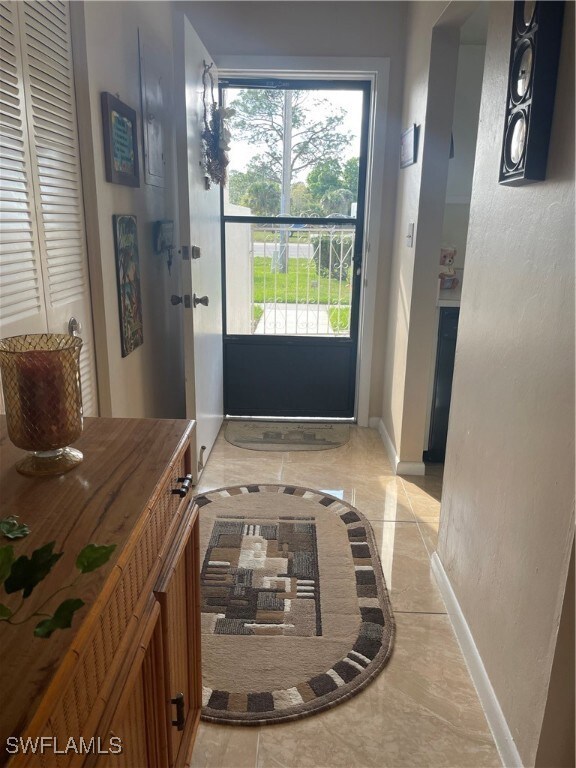 Doorway to outside with marble finish floor, a tex