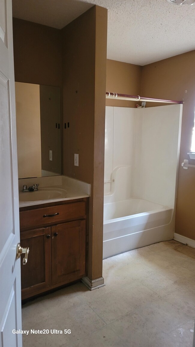Bathroom featuring vanity, a textured ceiling, and