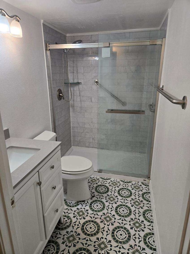 This bathroom features a modern design with a glas