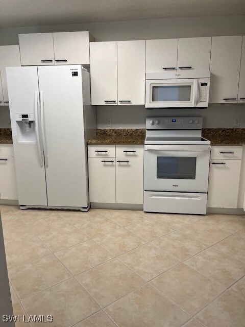 Kitchen with range, light tile patterned floors, r