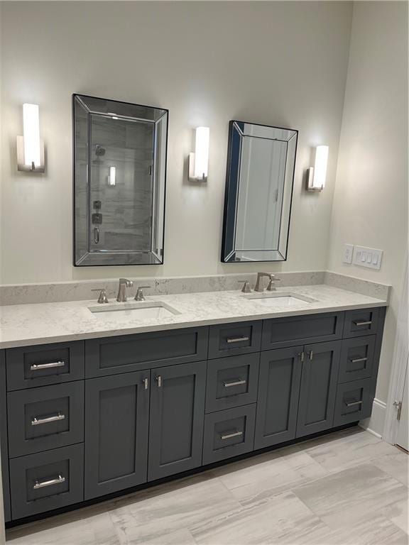 Bathroom featuring double vanity and a tile shower