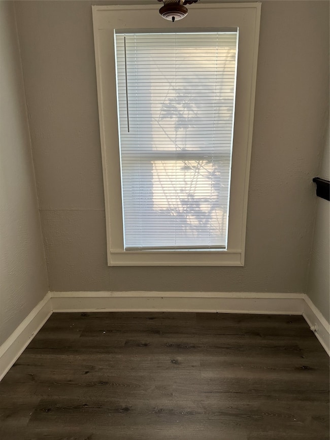 Detailed view of wood finished floors and a textured wall