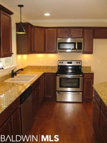 Custom granite sink and tons of cabinet space.