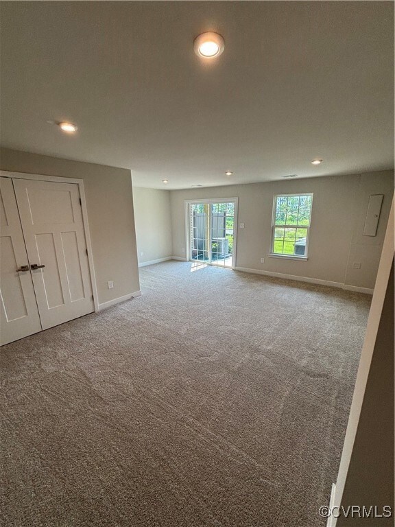 Carpeted spare room with recessed lighting and baseboards