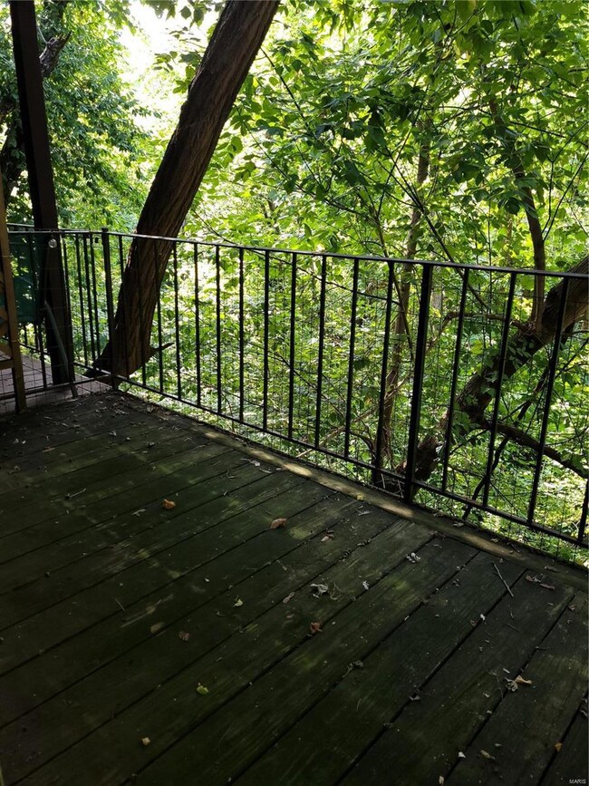 Deck overlooks wooded area