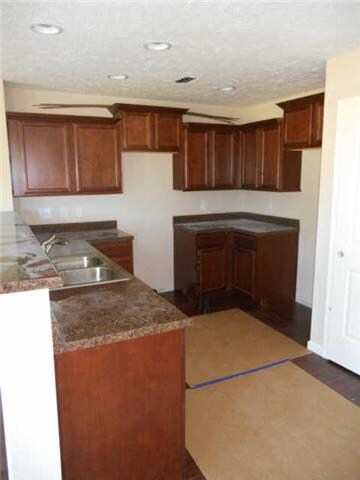 Kitchen with staggered cabinets, crown on top of cabinets, pantry, complete Whirlpool appliance pkge.