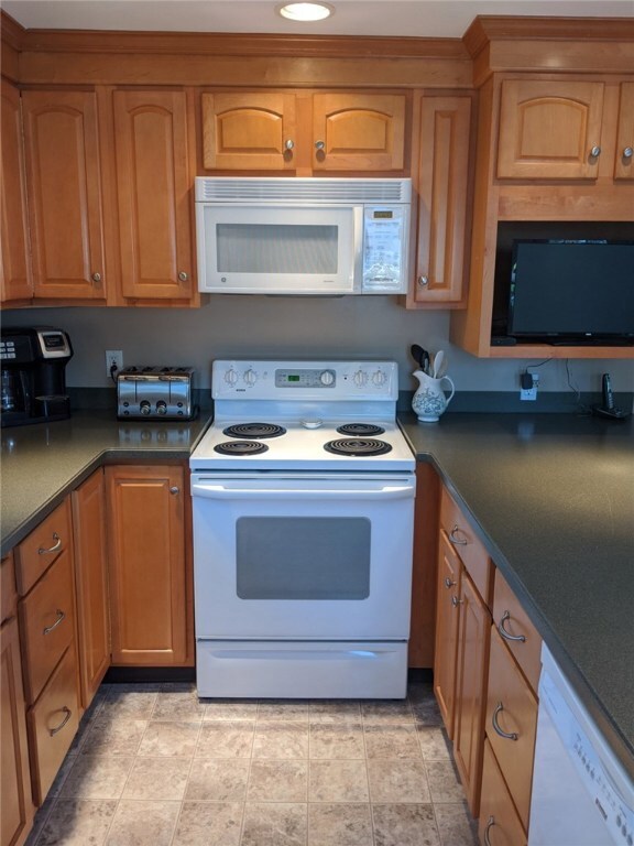 Kitchen equipped with modern refrigerator, range,