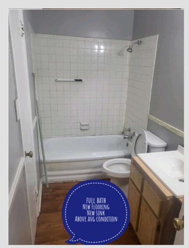 Full bathroom featuring vanity, toilet, wood-type 