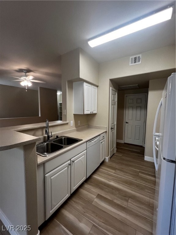 Kitchen featuring fridge, dishwasher, white cabine
