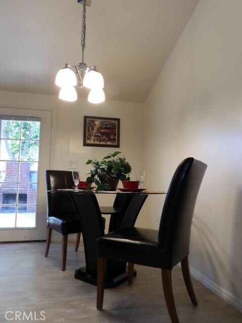 Dinning area with new light fixture, new porcelain tiles.