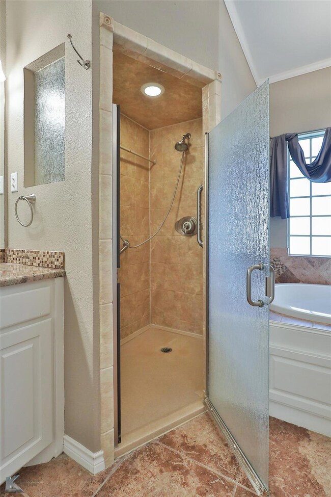 Bathroom featuring tile patterned flooring, vanity