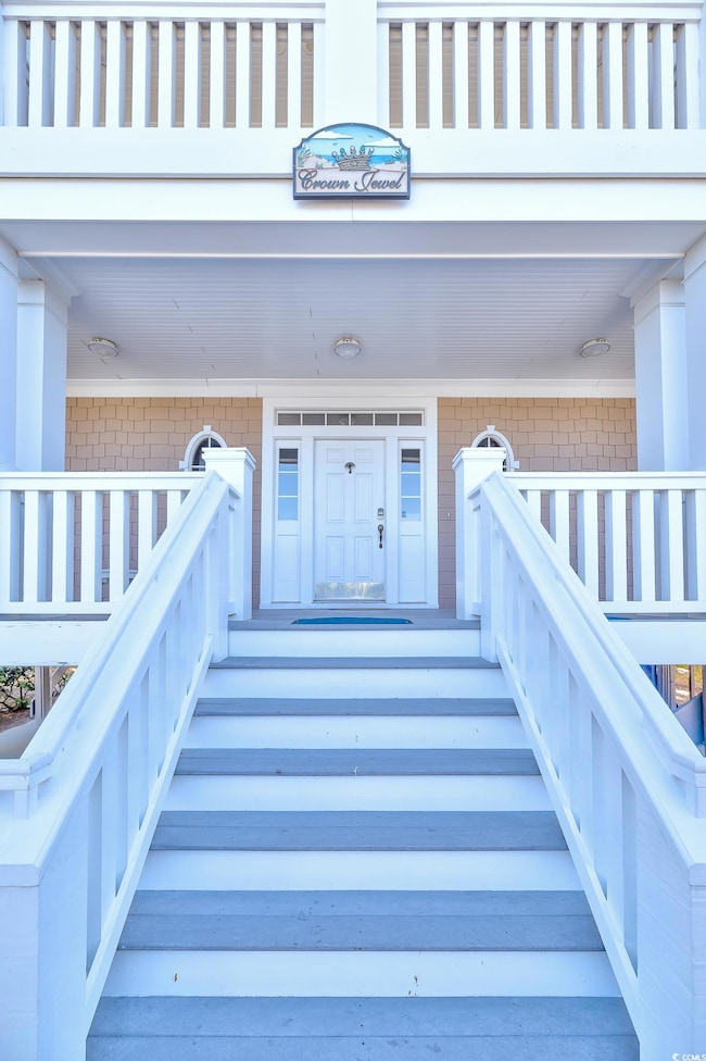 View of exterior entry featuring brick siding