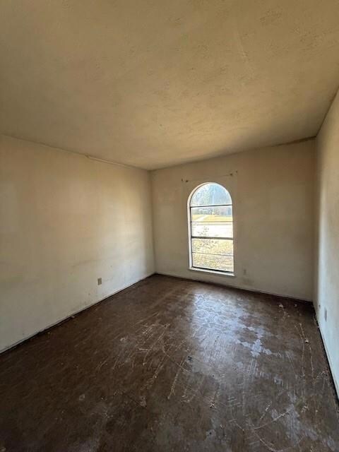 Unfurnished room with a textured ceiling