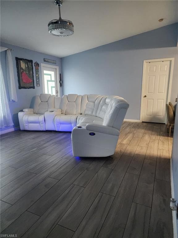 Living area featuring wood tile finished floors and baseboards