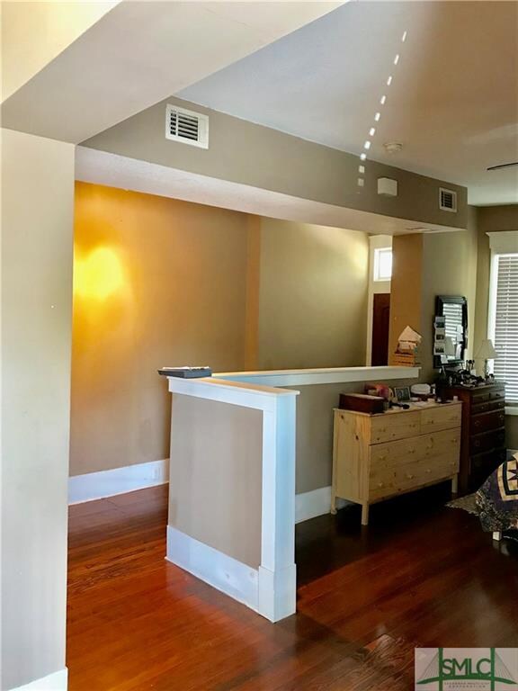 Entrance with half wall looking into the front roo