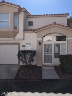 Entrance to property featuring concrete driveway,
